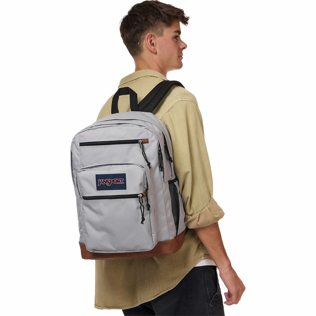 JanSport Cool Student Backpack with Synthetic Leather Trim Transfer - Light Gray - Left Angle On Model