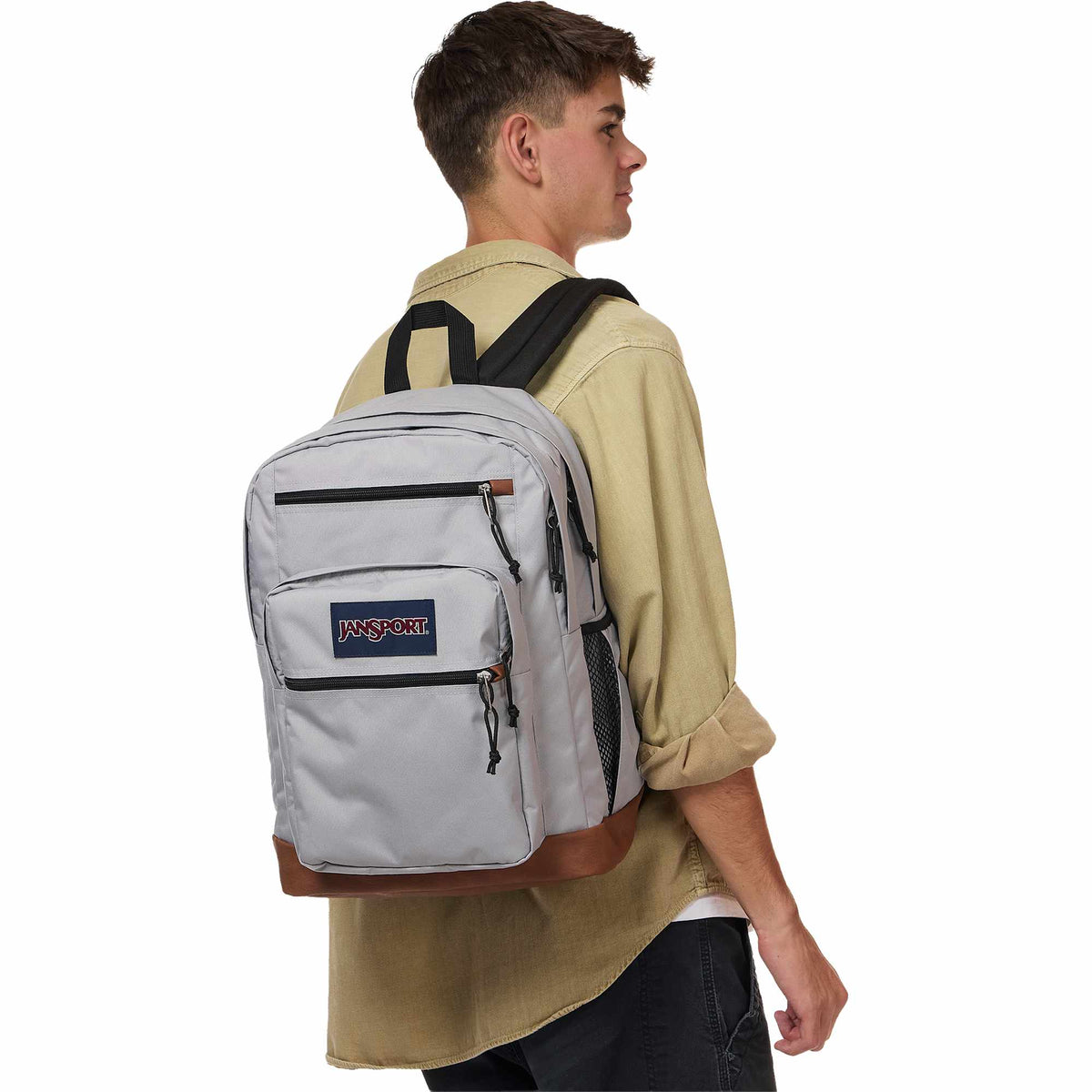 JanSport Cool Student Backpack with Synthetic Leather Trim Transfer - Light Gray - Left Angle On Model