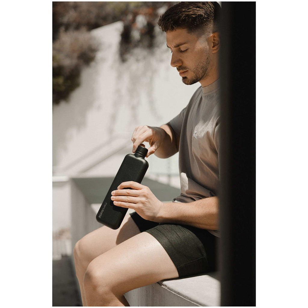 memobottle Slim Flat Stainless Steel Bottle, 20 oz Full Color - Black - Front Lifestyle 2