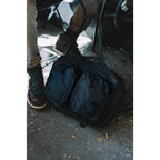 Topo Designs Global Briefcase with Backpack Straps Embroidery - Black - Left Angle Lifestyle